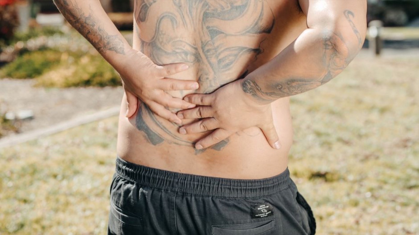 A man holding his lower back