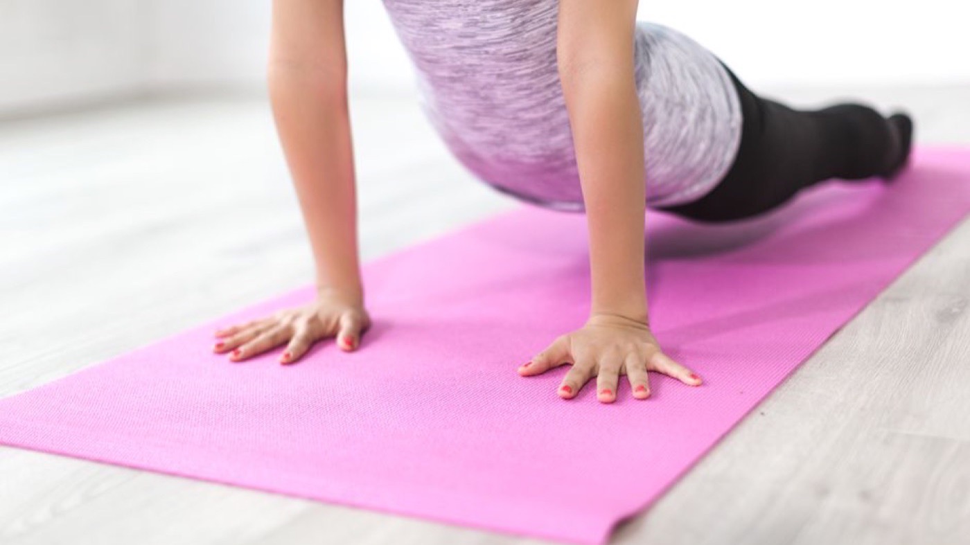 A woman stretching on an exercise mat